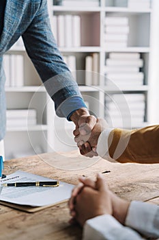 Close up shake hands, Considering buying a home, investing in real estate. Broker signs a sales agreement. agent, lease agreement