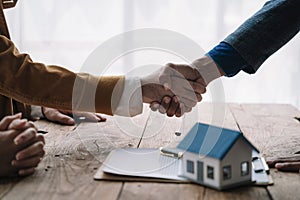 Close up shake hands, Considering buying a home, investing in real estate. Broker signs a sales agreement. agent, lease agreement