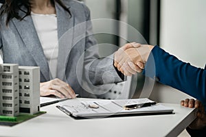 Close up shake hands, Considering buying a home, investing in real estate. Broker signs a sales agreement. agent, lease agreement