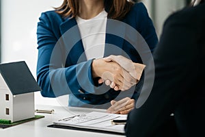 Close up shake hands, Considering buying a home, investing in real estate. Broker signs a sales agreement. agent, lease agreement