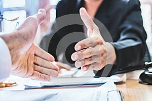 Close-up Shake hands lawyers in office. Counseling and Give an advice between private and government officials to find a fair