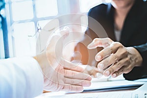 Close-up Shake hands lawyers in office. Counseling and Give an advice between private and government officials to find a fair