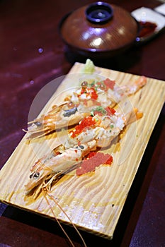 Close-up shallow focus shot of Japanese cuisine, cooked botan shrimp dish. Top with Tobiko(flying fish roe)