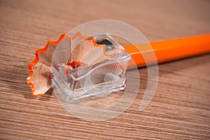 Close up of sharpener and orange pencil