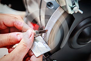 Sharpening the metal cutter on the grinding machine