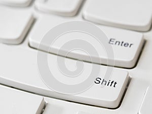 Close up of Shift Key on white keyboard of modern laptop