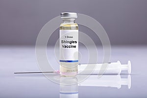 Close-up Of Shingles Vaccine And Syringe
