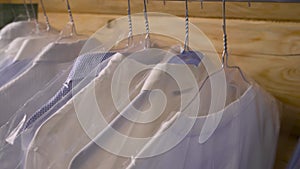 Close-up of shirts on hangers in the laundry room.