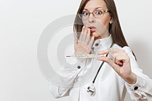 Close up shocked doctor woman in medical gown with stethoscope, glasses. Focus on clinical thermometer with high fever