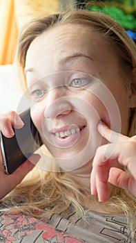 Close up of shocked woman hearing bad news over phone, scared female amazed by negative message received talking on cell