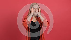 Close up of a shocked woman touching head, feeling amazement and full disbelief.