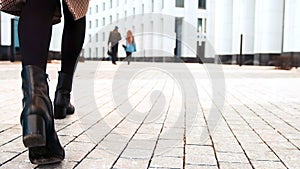 Close up shoes legs of businesswoman walking in modern city hurry time. Business concept. Asian hieroglyph on the