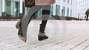 Close up shoes legs of businesswoman walking in modern city hurry time. Business concept. Asian hieroglyph on the
