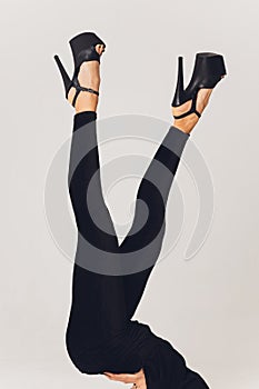 Close up shoes for pole dance with high heels on legs.