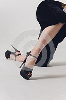 Close up shoes for pole dance with high heels on legs.