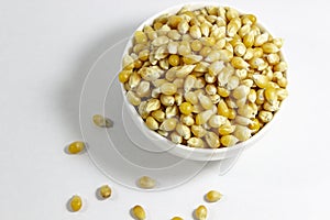 Close-up shoot of corn seeds in white small cup with natural concept