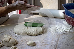 Close-up shoot of dough preparation to make traditional turkish bread food with flours.