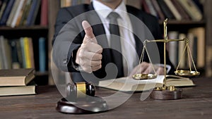 Close up Shoot of Judge Hand showing Thumbs Up in Court Room