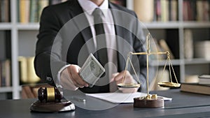 Close up Shoot of Lawyer Hand offering Money in Court Room