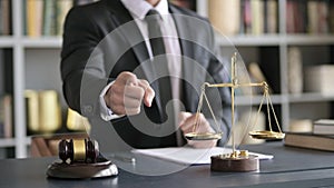 Close up Shoot of Lawyer Hand pointing Finger in Court Room Table