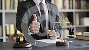 Close up Shoot of Lawyer Hand showing Thumbs Up in Court Room