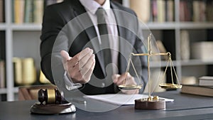 Close up Shoot of Lawyer Hand sign for asking Money in Court Room