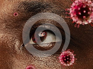 Close up shoot of a male eye with 3D-illustrated coronavirus models, the way of infecting