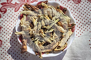 Close-up shoot of traditionally dried under sun string beans on transparent with small cup
