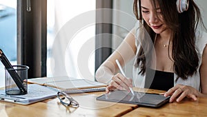 Close up shoot of a young businesswoman at the workplace using her digital tablet