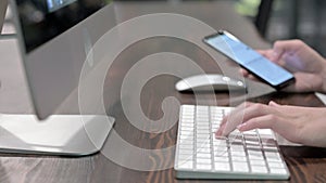 Close Up Shoot of Young Woman Hands using Smartphone and Keyboard