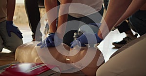 Close-up shooting: Two people perform CPR with the help of a mannequin and an Ambu resuscitation bag. Practical training