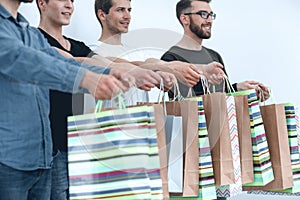 Close up.shopping bags in the hands of a group of young people