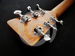 close up shot of acoustic guitar tuning machine, open gear