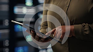 Close up shot of admin working in data center using tablet