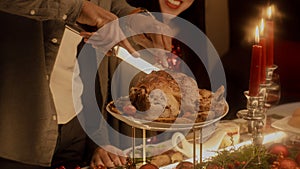 Close-up shot of African American man cutting turkey on Christmas