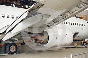 Close up shot of aircraft engine jet under maintenance in the hangar indoors