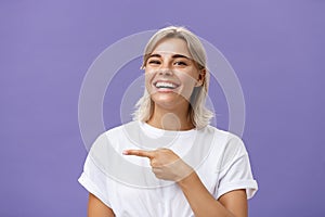 Close-up shot of amused happy and entertained good-looking sociable woman with fair hair and beautiful smile grinning