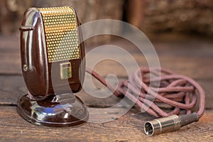 Close up shot of a antique 50s microphone with cables and box.