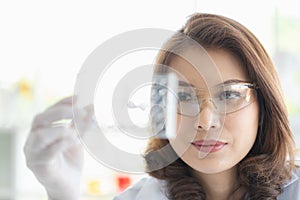 Scientist holding test tube tray in her hand