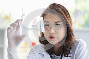 Scientist holding test tube tray in her hand