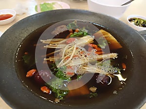 Close-up shot of the Bak kut teh; Hokkien in the black pot.