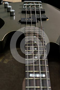 A close-up shot of bass guitar strings showcasing their texture and alignment.