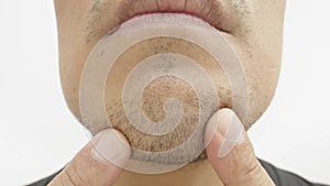 Close-up shot of a bearded Asian\'s face.