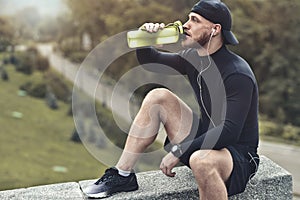 Close-up Shot Bearded Sportive Man take a rest and drink a water After Workout Session.