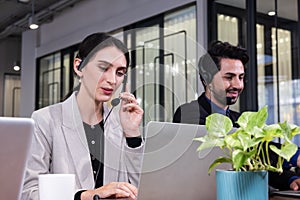 Close up shot of beautiful Caucasian business women with suit formal dress. Using headphone with mic while taking on the phone