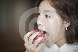 beautiful woman open wide mouth to bite the red apple