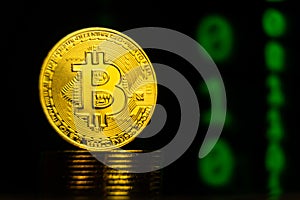 Close up shot of bitcoin with binary code blockchain background