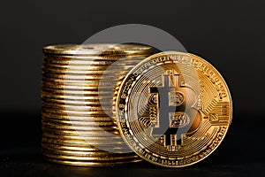Close up shot of Bitcoin coins on black background,  A pile of Bitcoin Cryptocurrency Gold Bitcoin BTC Bit Coin.  Digital