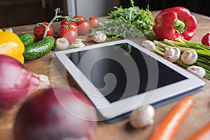 close-up shot of blank tablet with vegetables