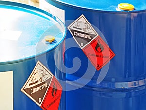 The close-up shot of blue color hazardous dangerous chemical barrels ,have warning labels of corrosive & flammable liquid photo